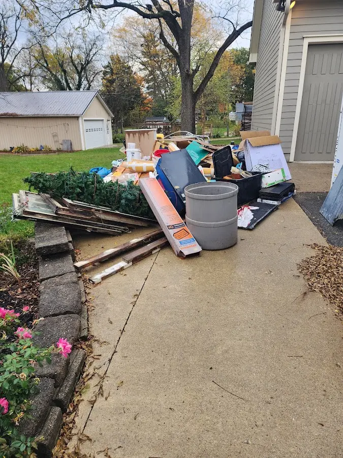 Dumpster being loaded with debris for Estate Cleanout Dumpster Rental in Cotulla
